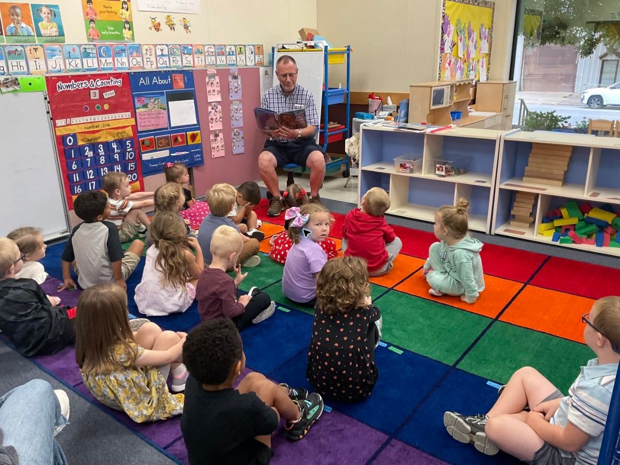 Gem City Kiwanis member reading with area children
